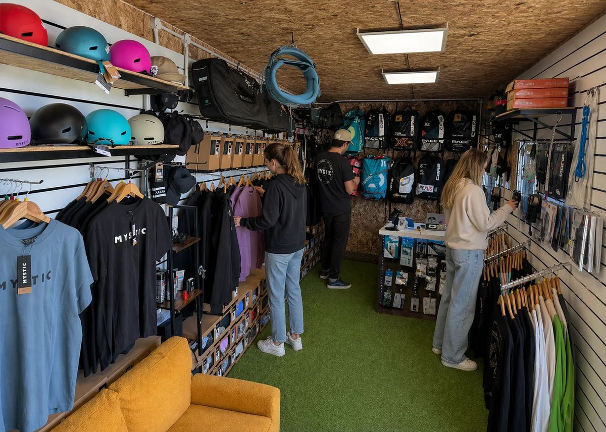 Inside the Northern Watersports shop, with customers browsing helmets, wetsuits, kites and clothing